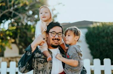 Fair Housing - person with two children in front of a house